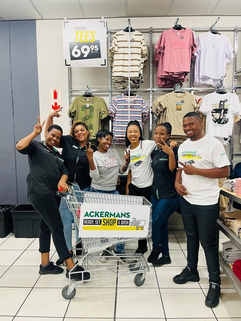 Isilumko-Activate A street-level marketing team posing for a photo in a store.
