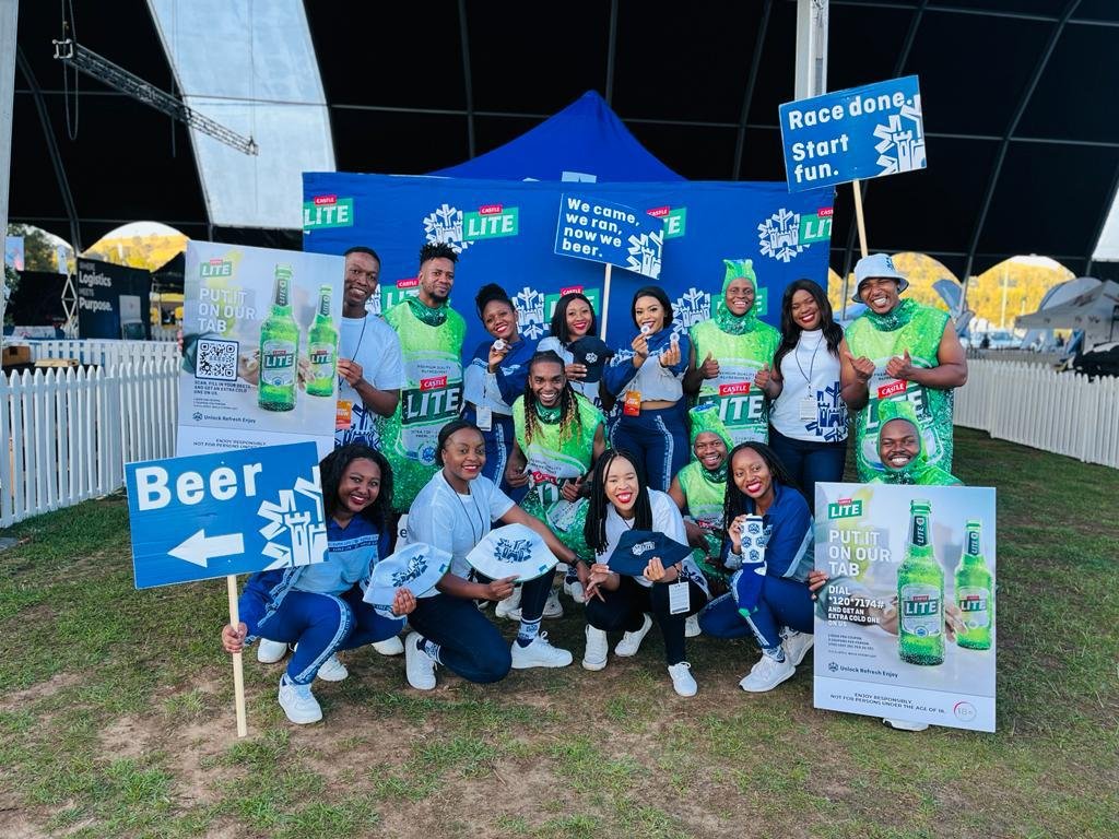 Isilumko-Activate A group of people posing in front of a tent, showcasing marketing for small business ideas.