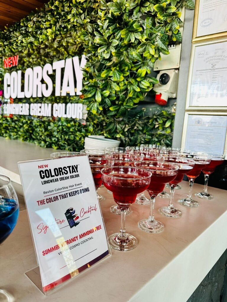 Isilumko-Activate A vibrant bar showcasing a variety of glasses of wine, strategically positioned alongside a captivating sign that elegantly promotes the concept of "colorstay.