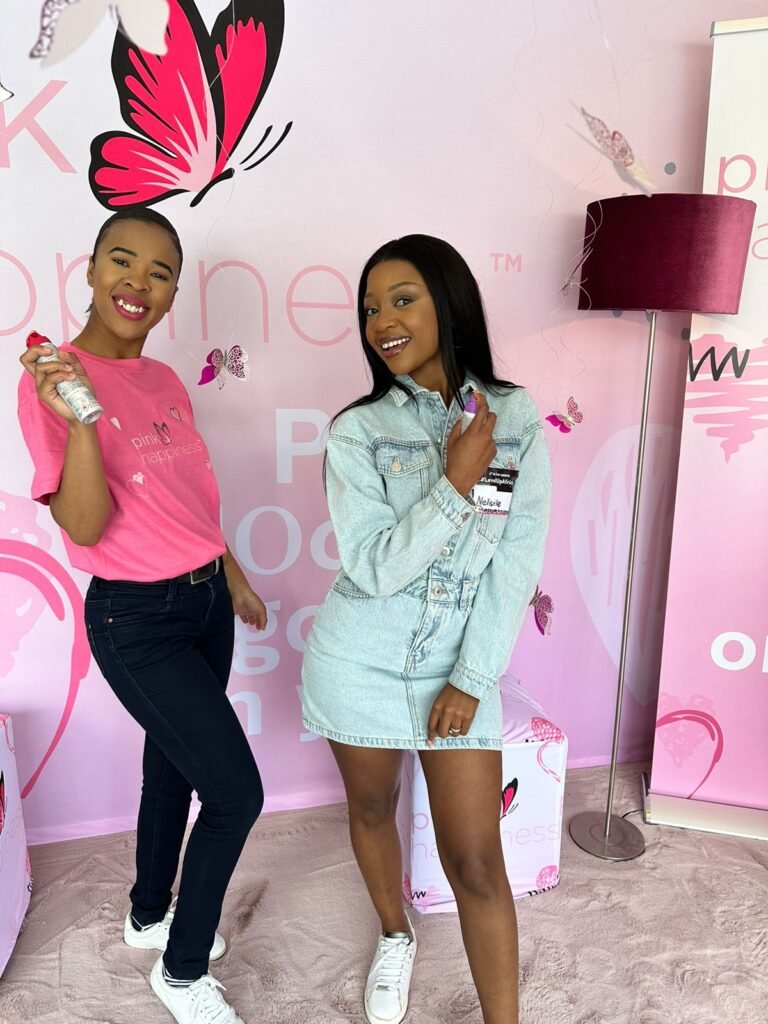 Isilumko-Activate Two women posing in front of a pink wall.